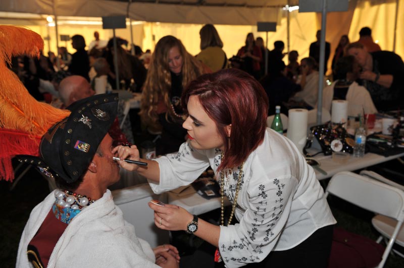 Christina Lumsford working on a pirate doing the makeup